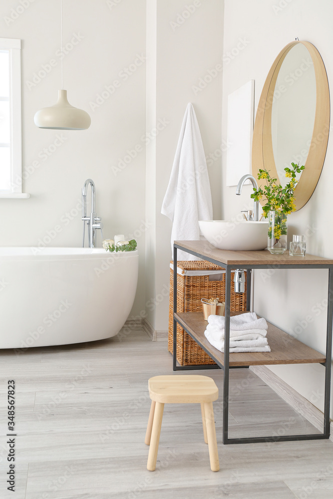 Interior of bathroom with fresh flowers