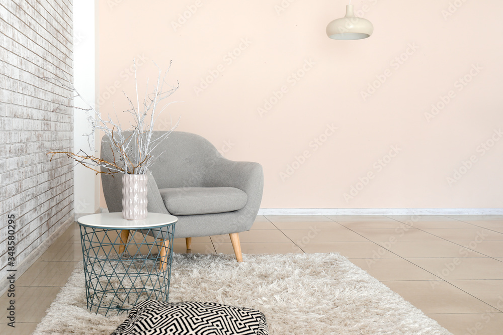 Comfortable armchair and table in interior of living room