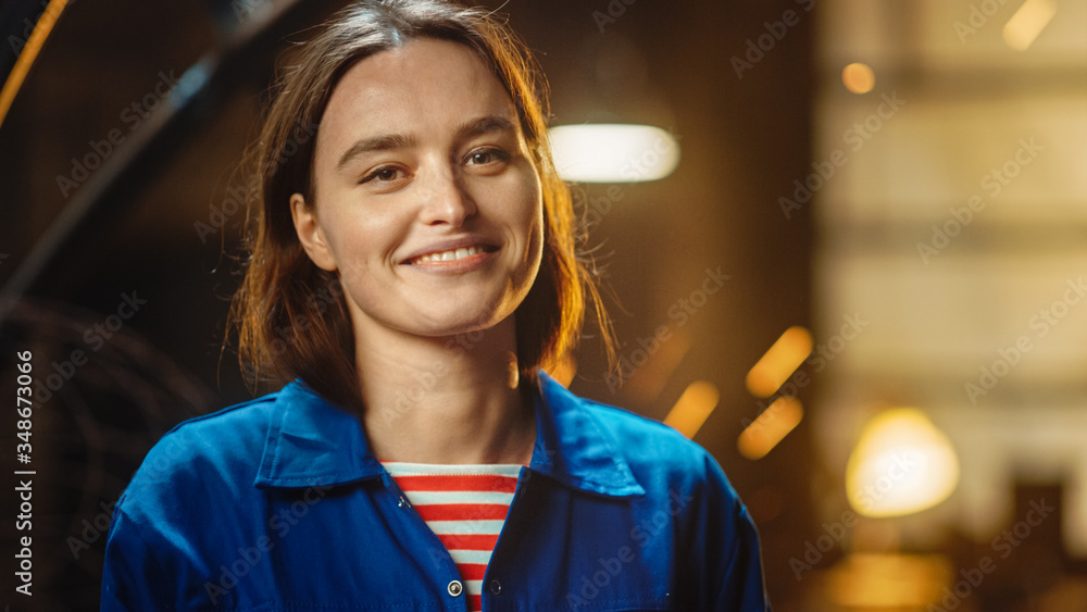 Young Beautiful Empowering Woman Gently Smiles at the Camera. Authentic Fabricator Wearing Work Clot