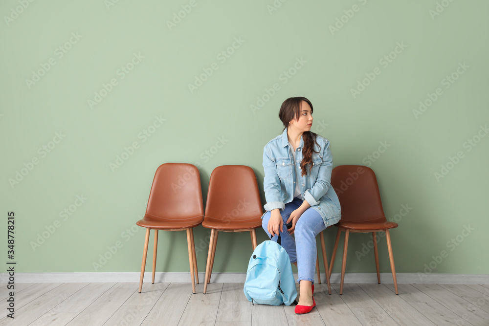 Young woman waiting for her turn indoors