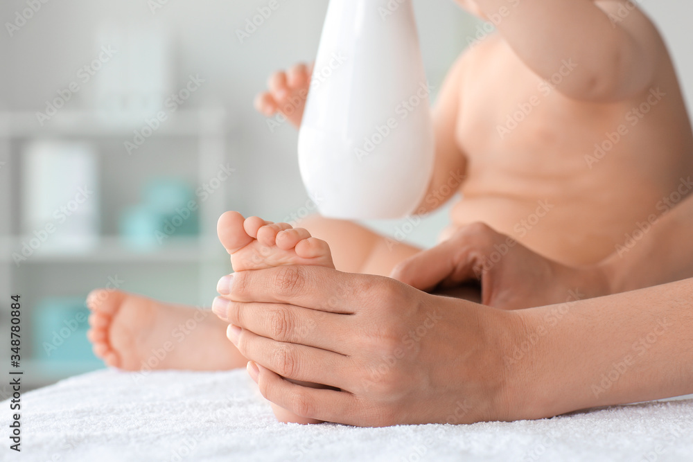 Massage therapist working with cute baby in medical center