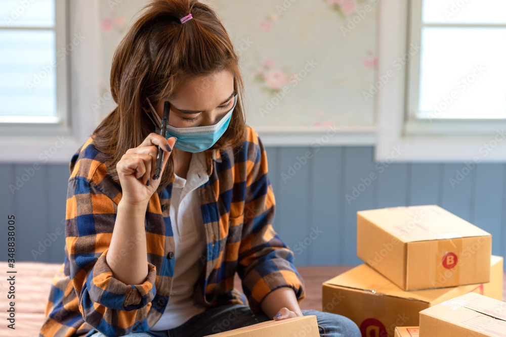 Asian women working sit and think about marketing analysis from home in room floor with postal parce