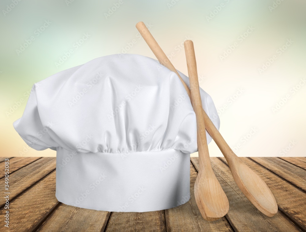 White chef hat with wooden spoons