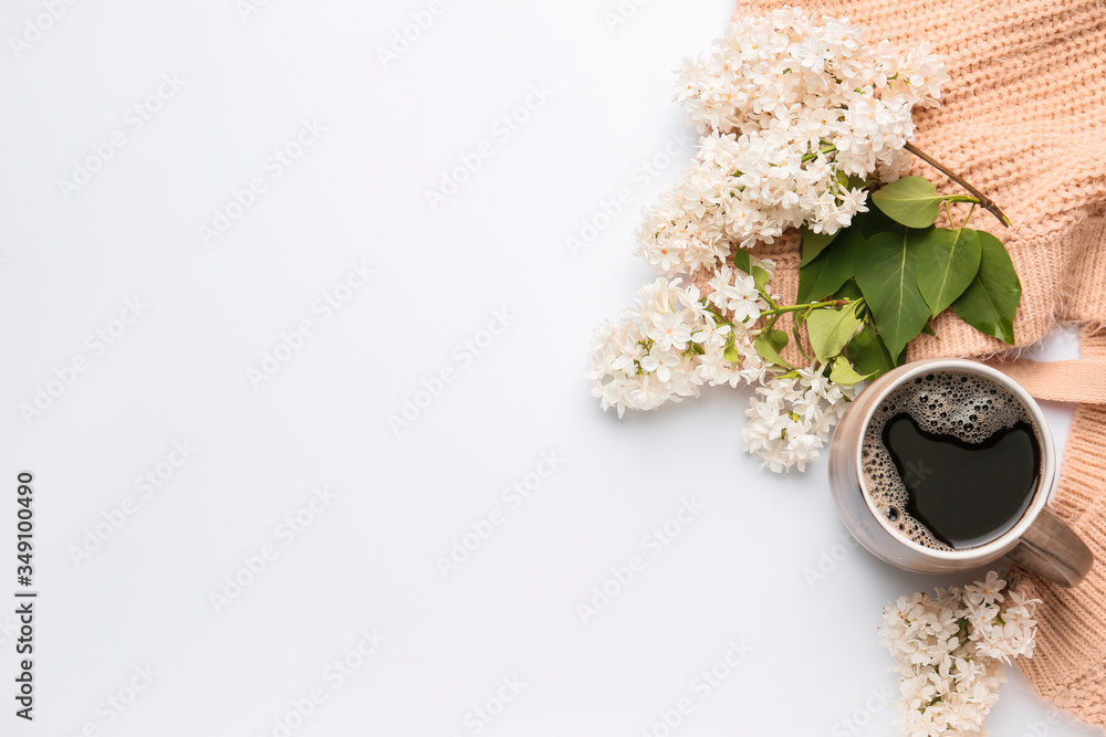 Beautiful lilac flowers, plaid and cup of coffee on white background