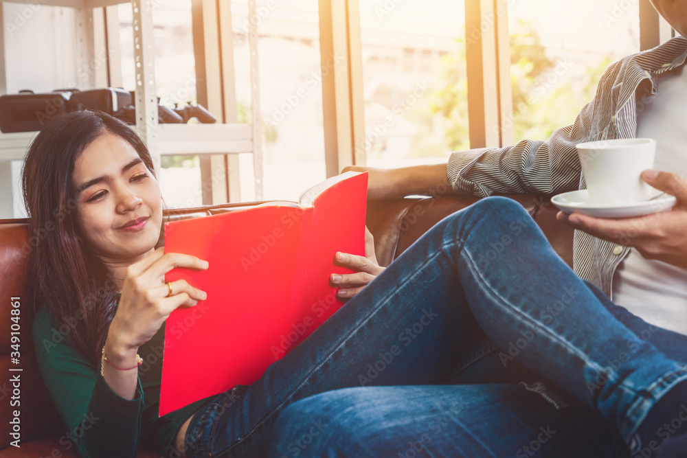 Happy Asian couple drink coffee at home. Love relationship and lifestyle concept.