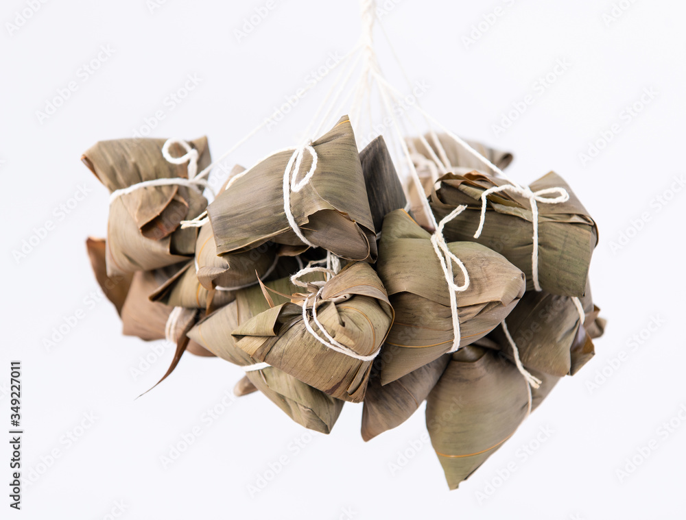 Rice dumpling zongzi making - wrapping Chinese rice dumpling zongzi on table at home for Dragon Boat