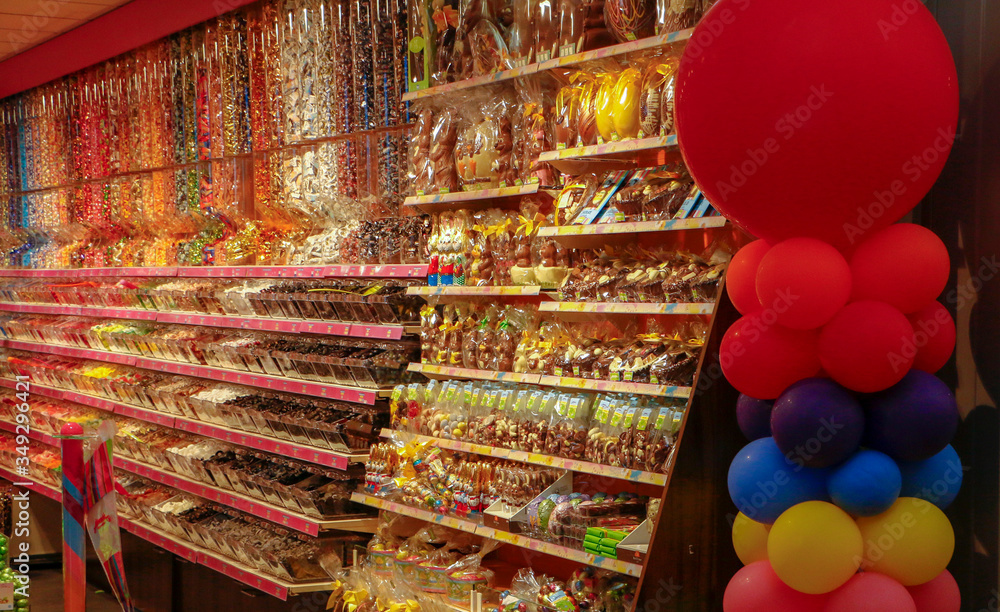 Various sweets and snacks on the shelves. Interior of a sweet shop