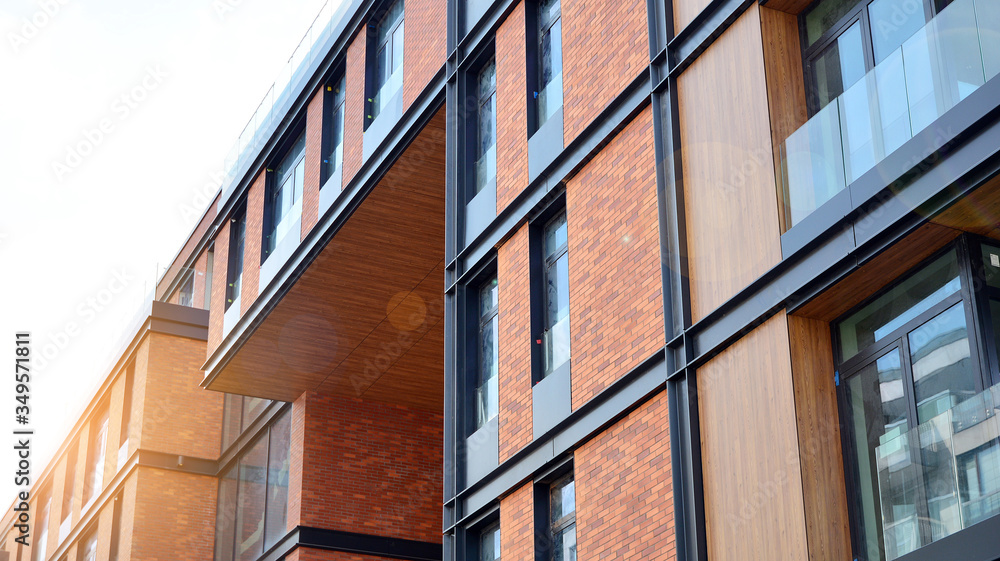 Modern apartment buildings on a sunny day with a blue sky. Facade of a modern apartment building. Gl