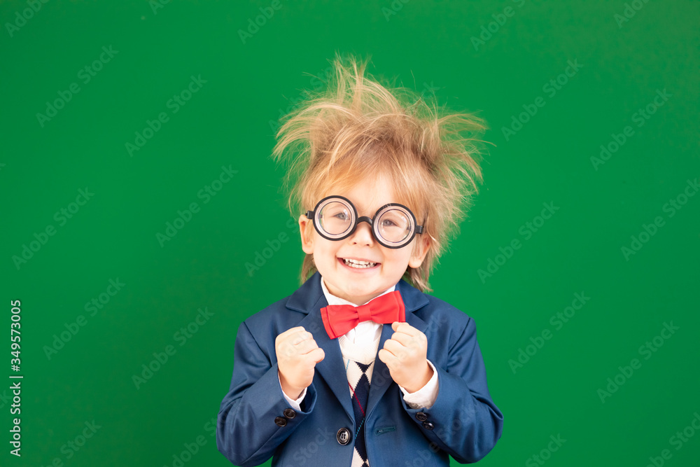 Bright idea! Happy child student against green chalkboard