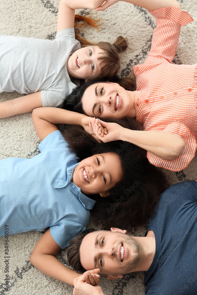 Happy couple with little adopted children at home