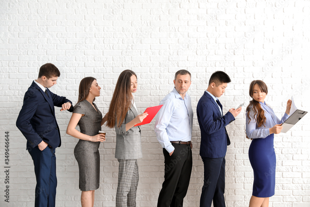 Business people waiting in line indoors