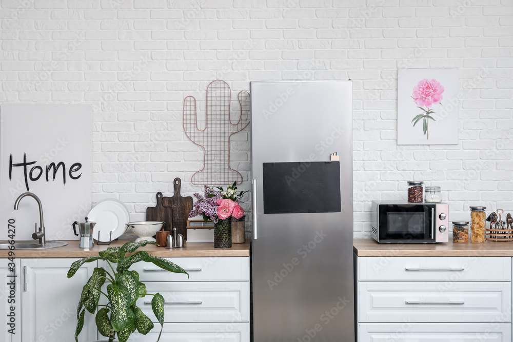 Stylish interior of modern kitchen with big refrigerator