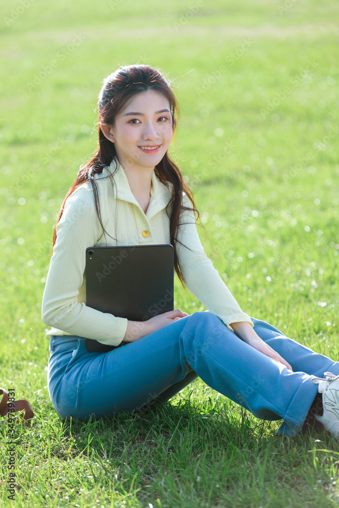 Asian girl sitting on the grass