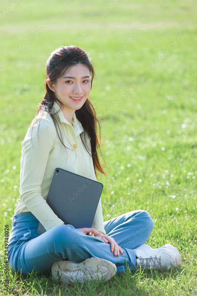 Asian girl sitting on the grass
