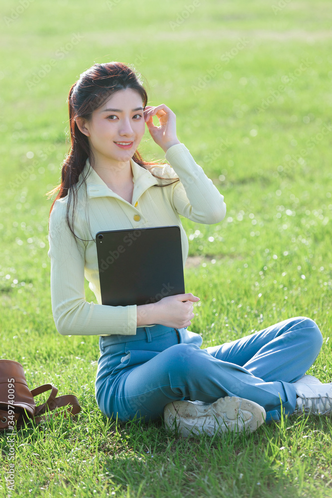 Asian girl sitting on the grass