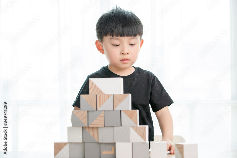 Asian little boy playing with building blocks