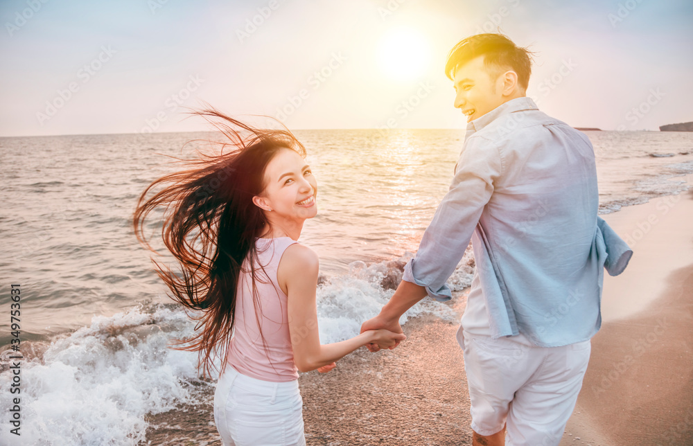 happy and Romantic couple having fun on the beach at sunset