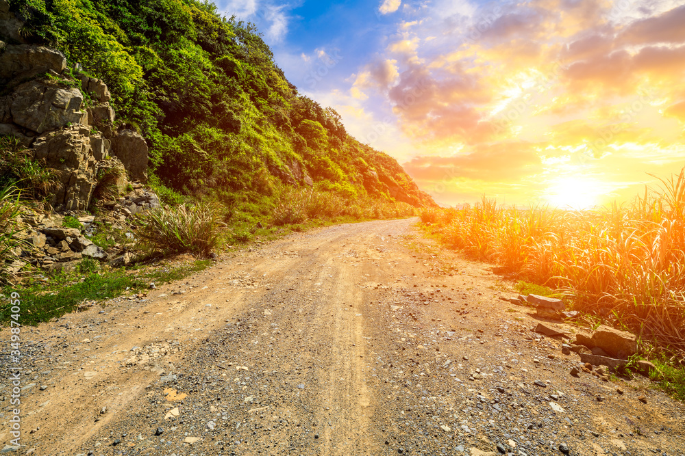 Gravel road and mountain landscape by the sea.