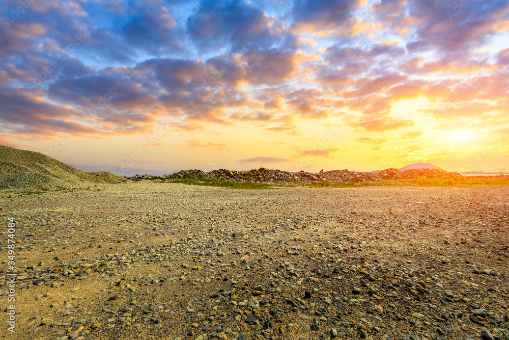 Gravel road pavement and sky sunset clouds.