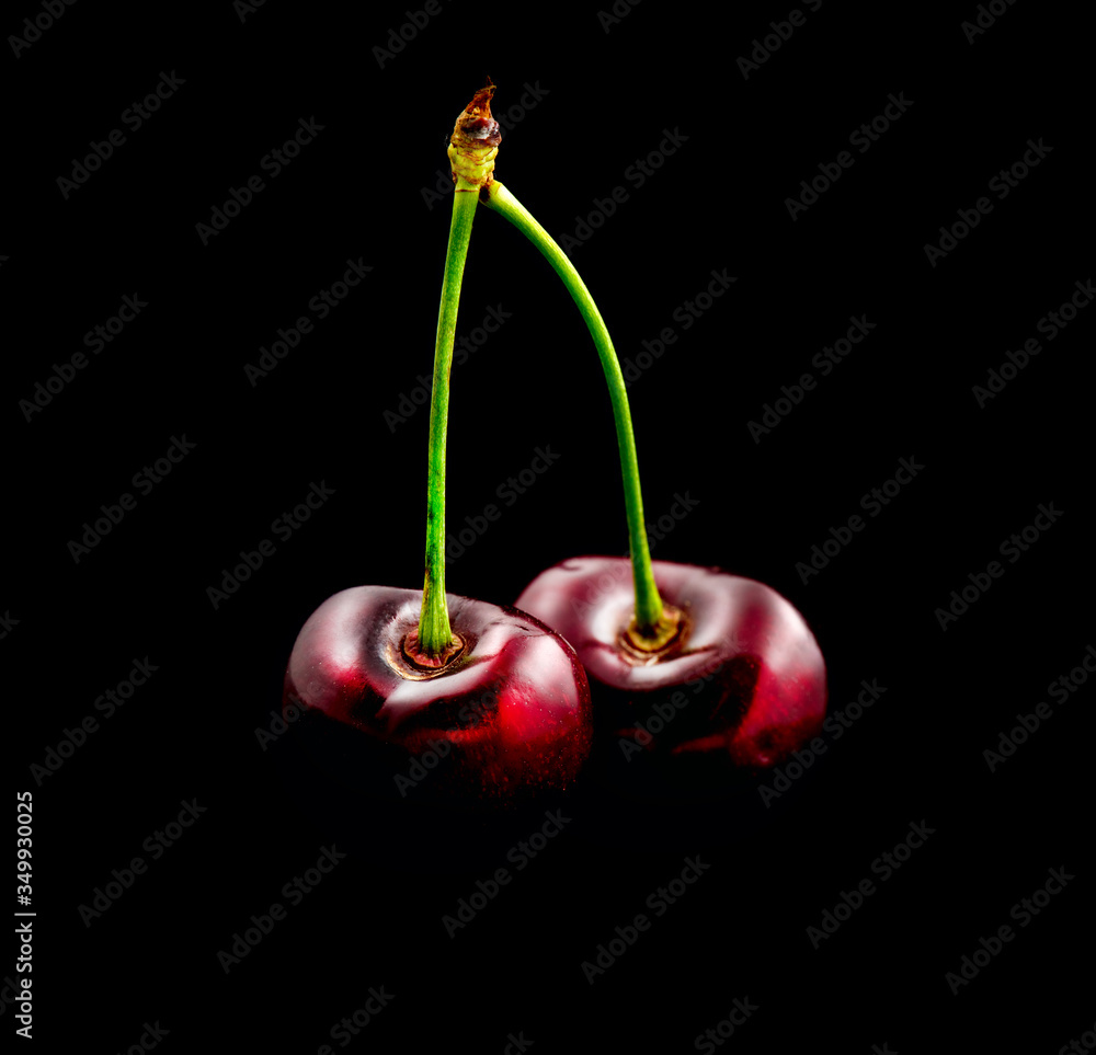 Fresh ripe Cherry close-up. Organic red cherries isolated on black background. Sweet delicious Berri