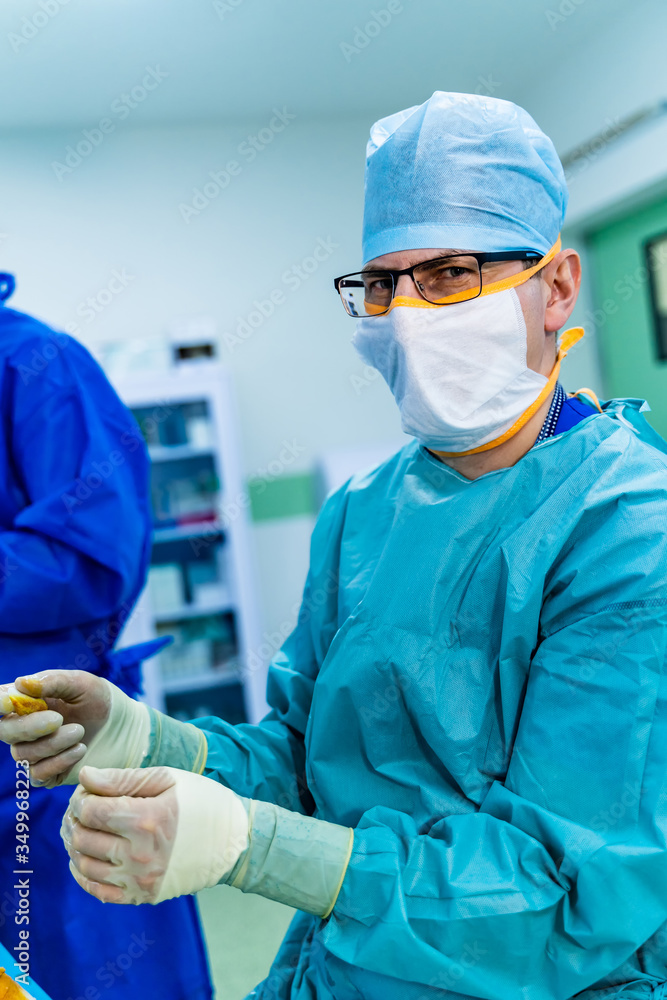 Portrait of a doctor or medical specialist. Vertical portrait. Man in scrubs. Light background with 