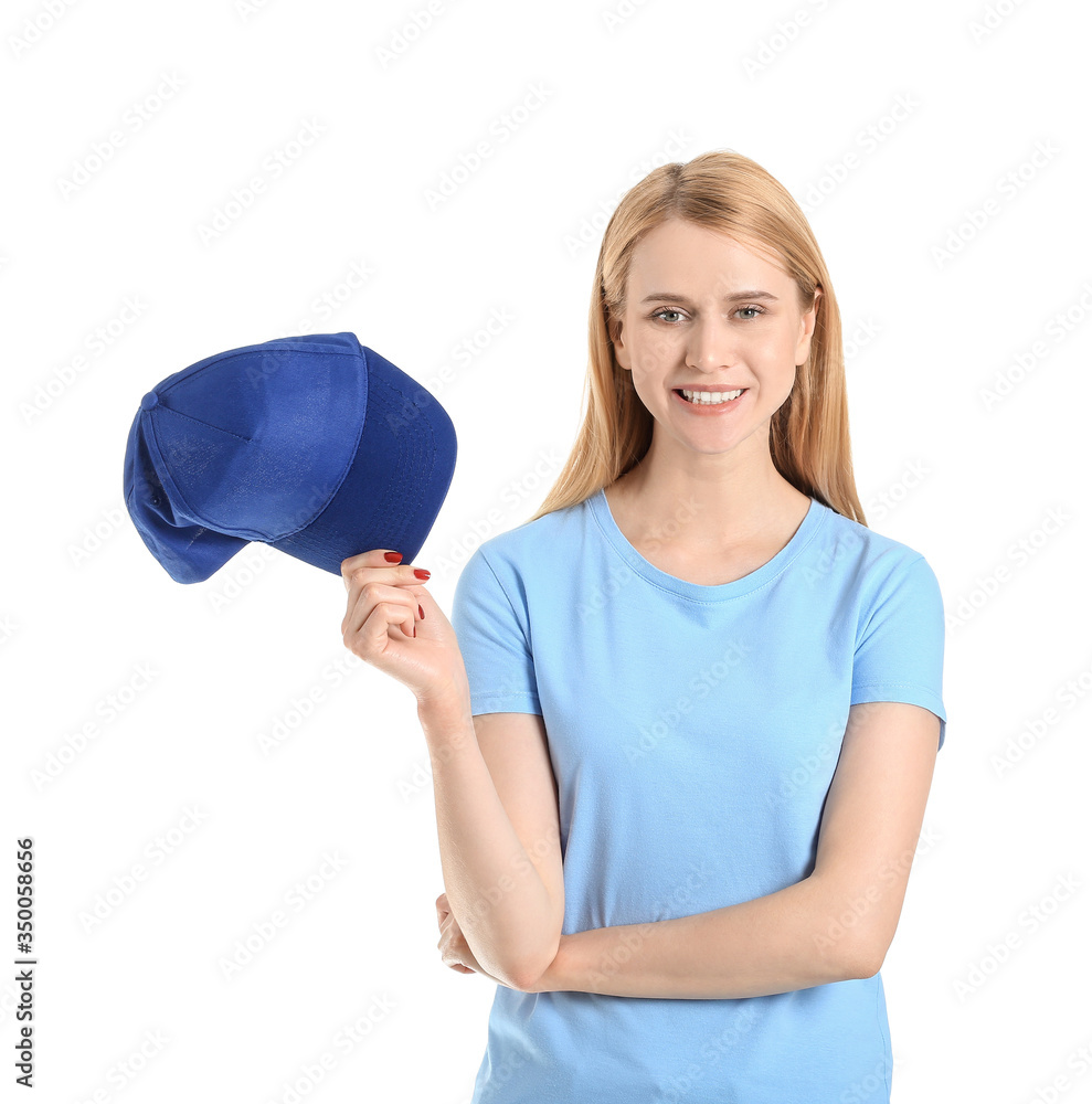 Beautiful young woman with stylish cap on white background