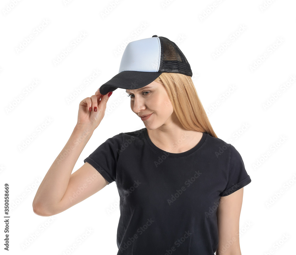 Beautiful young woman in stylish cap on white background