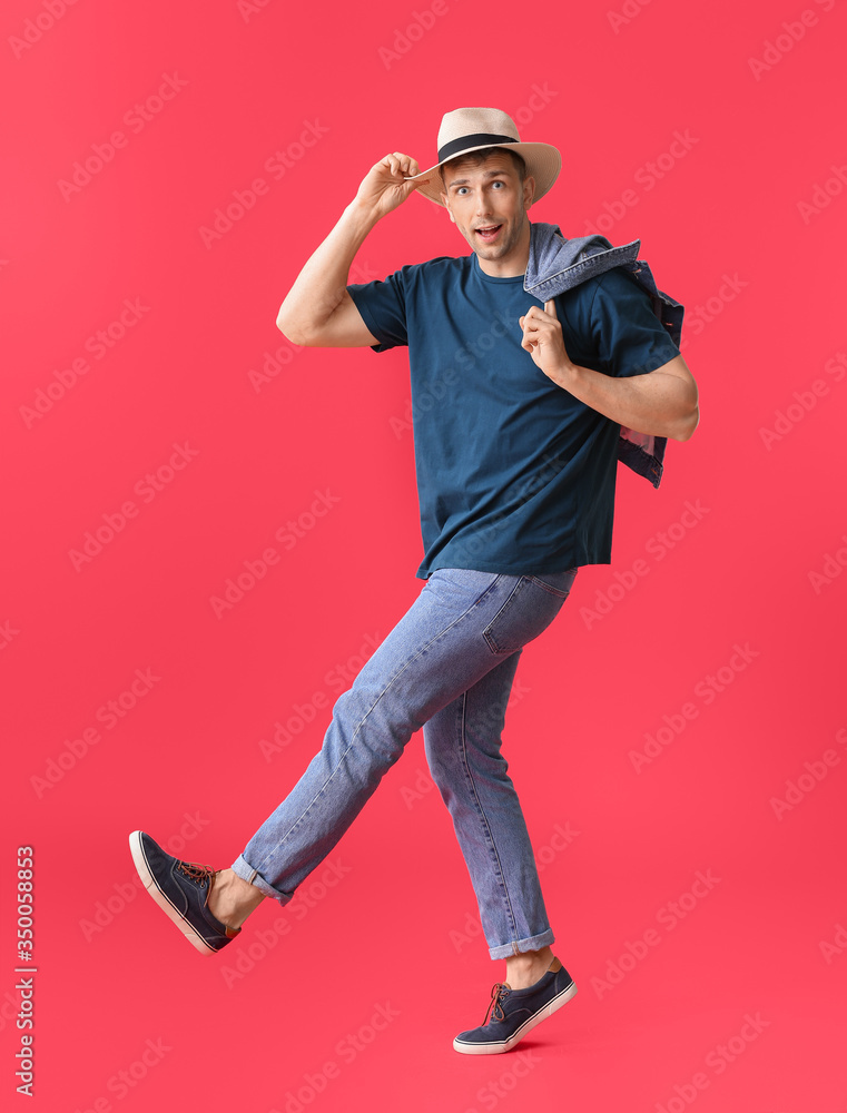 Man in stylish t-shirt on color background