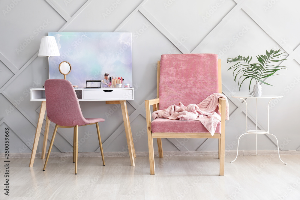 Interior of modern room with comfortable armchair and dressing table