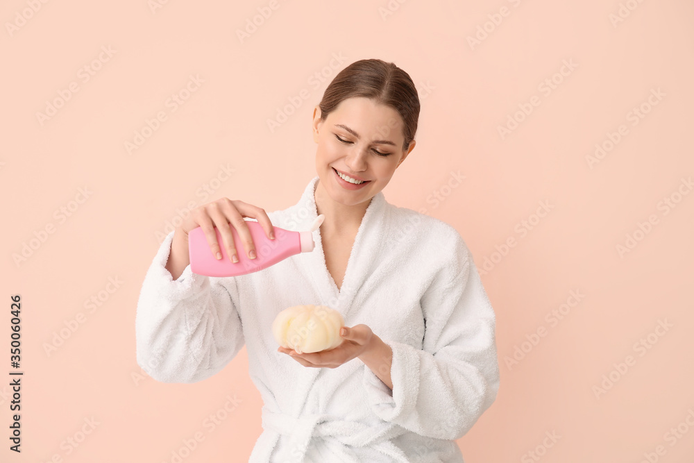 Beautiful young woman with shower gel on color background