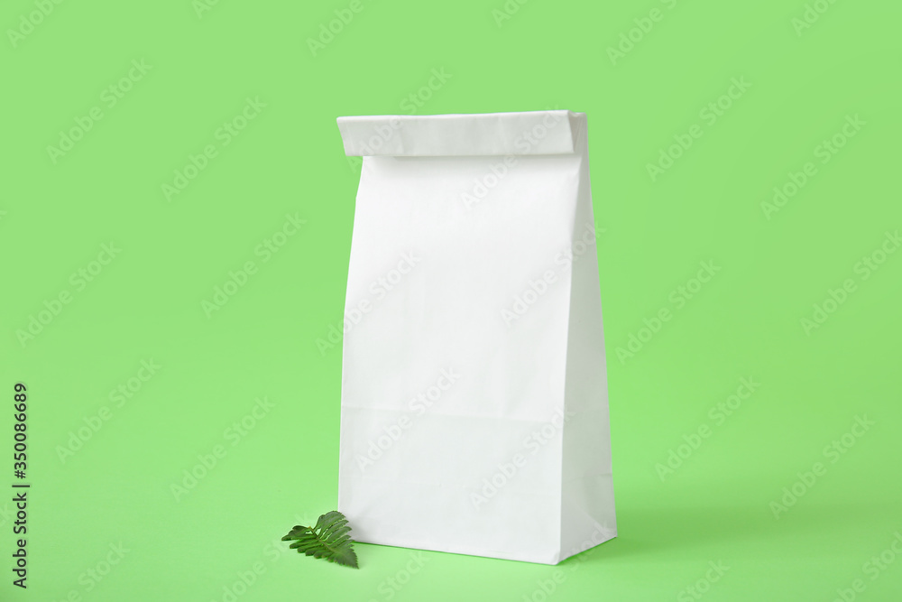 Paper bag on color background