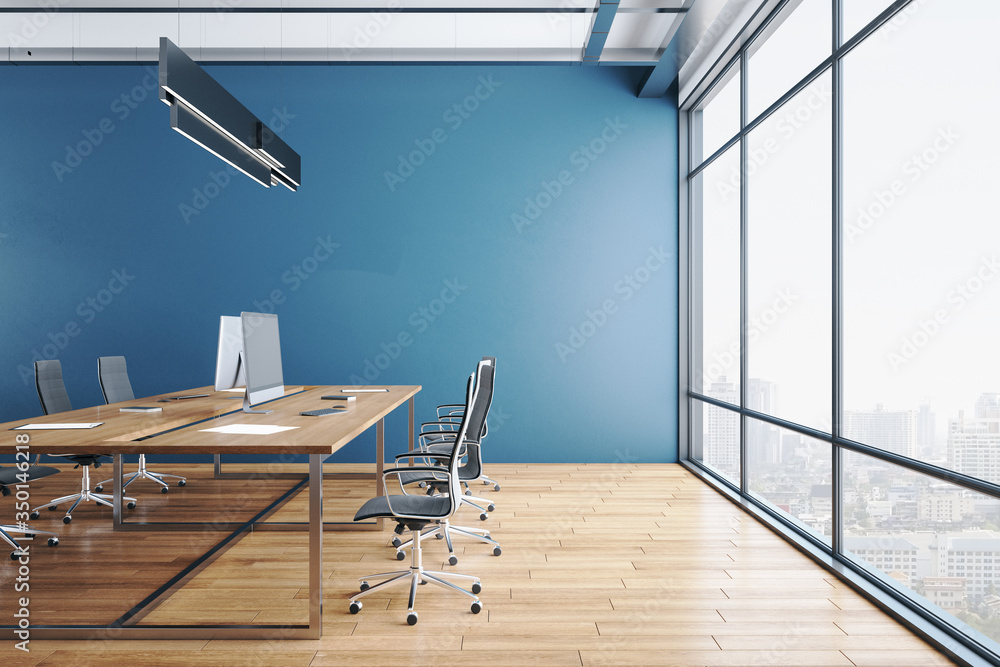 Modern coworking office interior with equipment on desktop