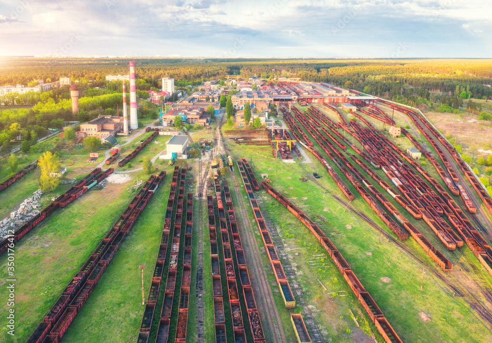 Aerial view of freight trains. Railway station with wagons. Heavy industry. Industrial landscape wit