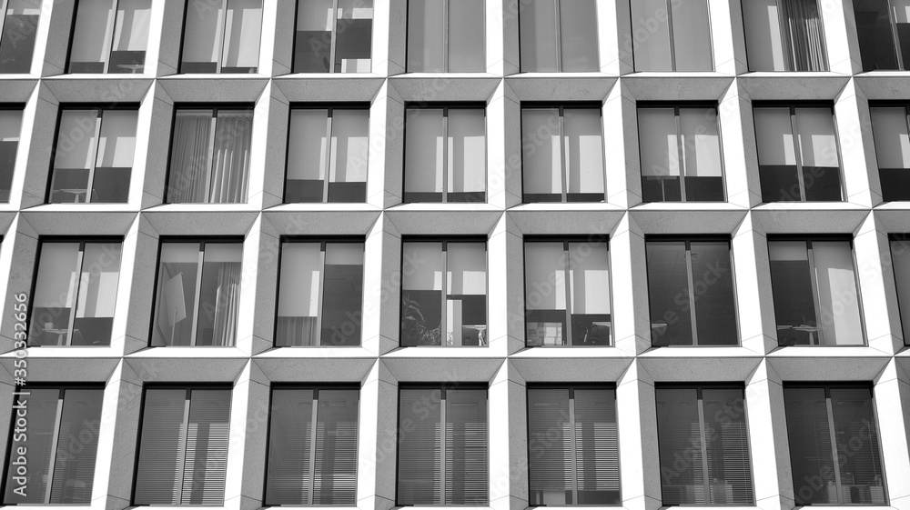 The windows of a modern building for offices. Business buildings architecture. Black and white.