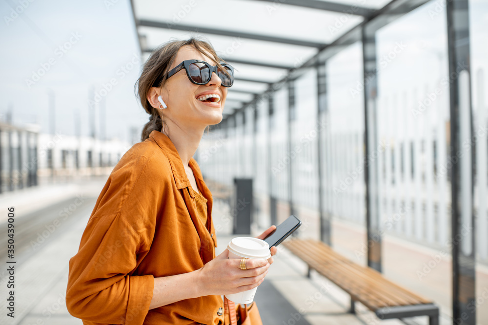 Woman waiting at the transport stop