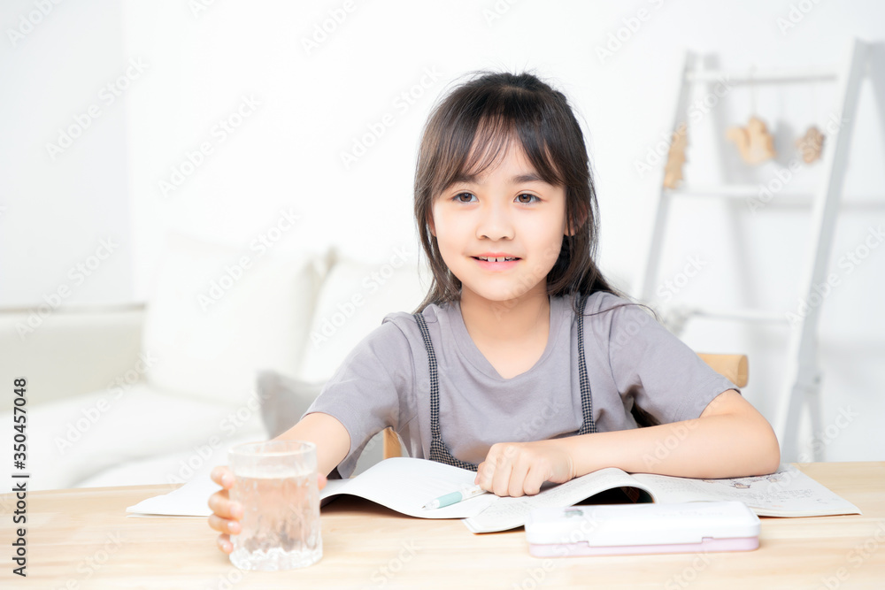 Asian little girl doing homework