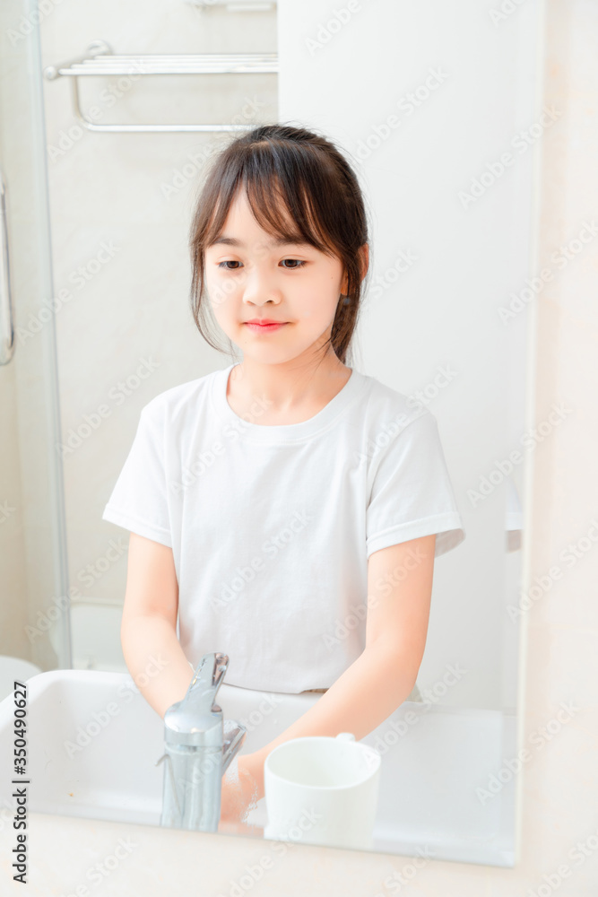 Asian little girl washing hands