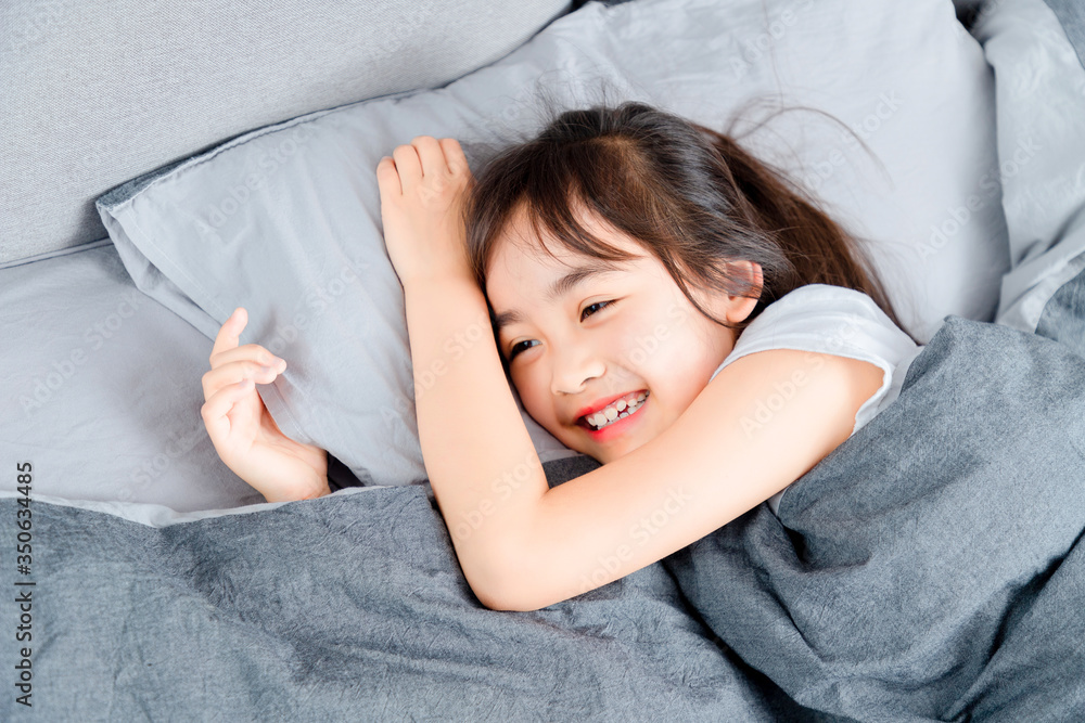 Asian little girl sleeping in bed