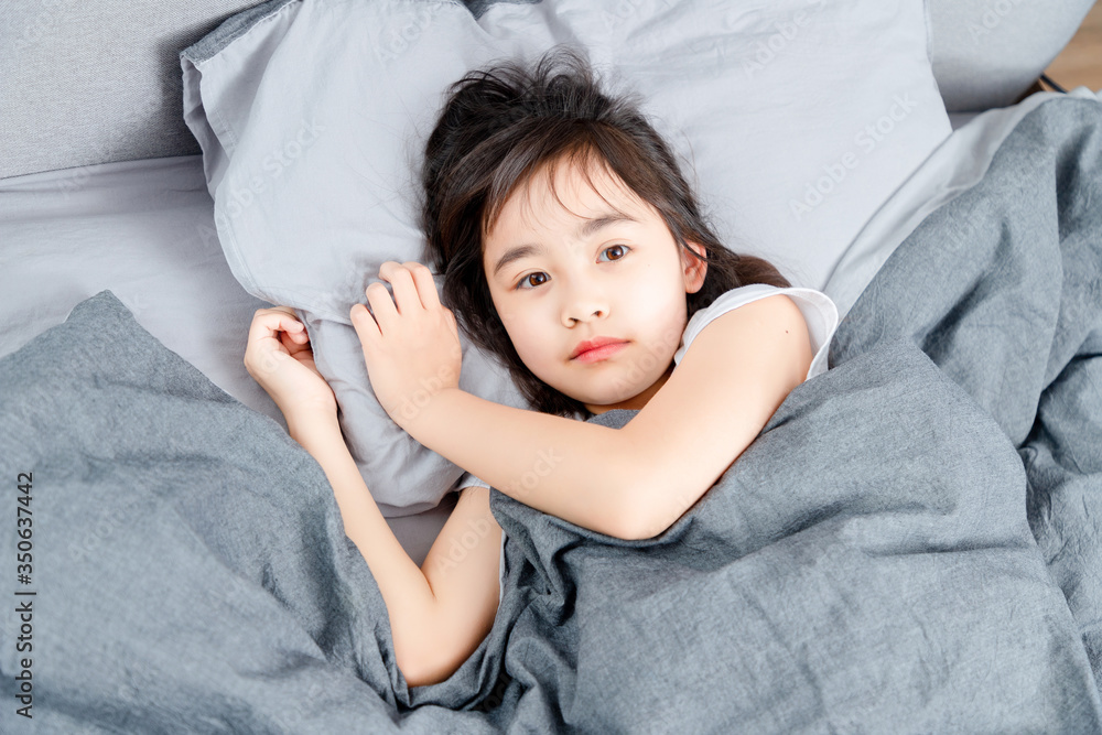 Asian little girl sleeping in bed