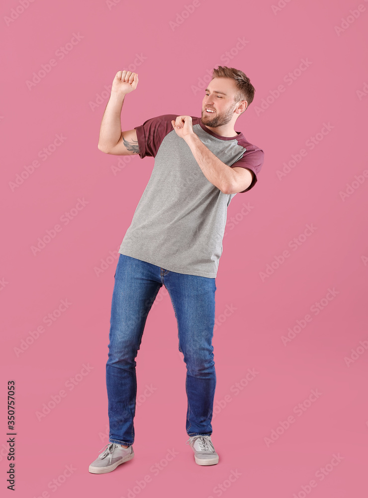 Handsome dancing man on color background