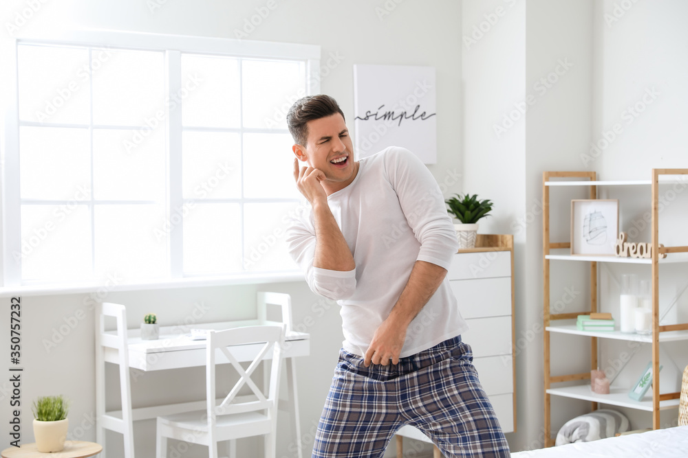 Handsome young man dancing at home