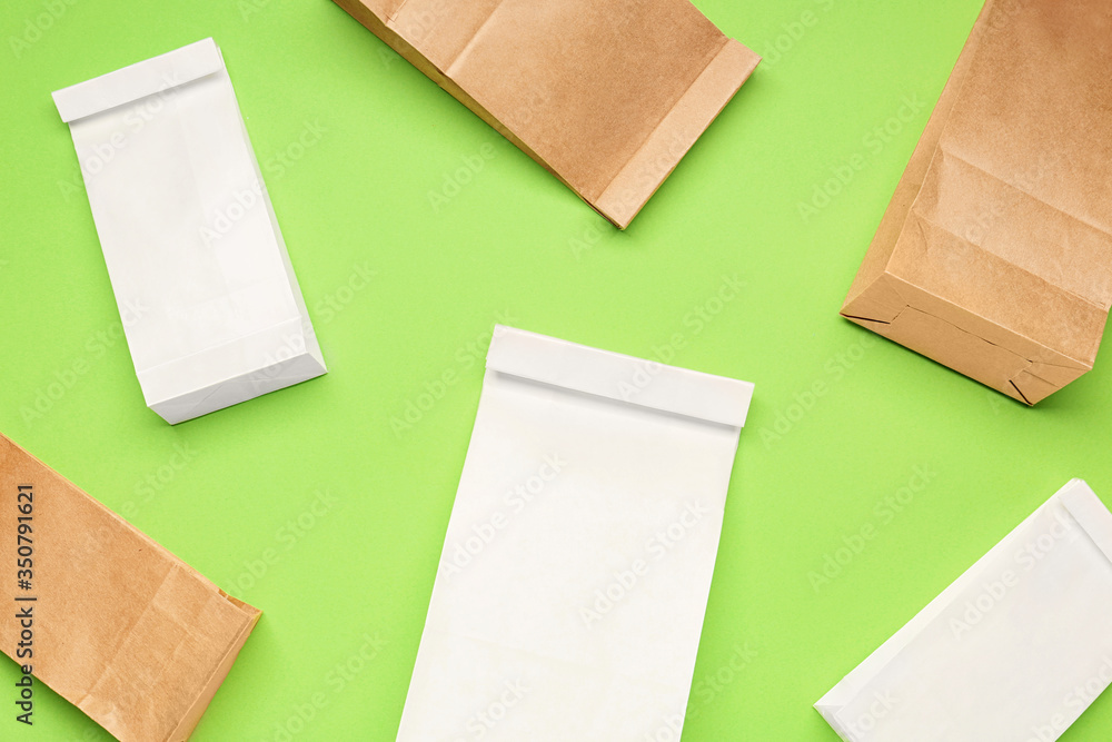 Paper bags on color background