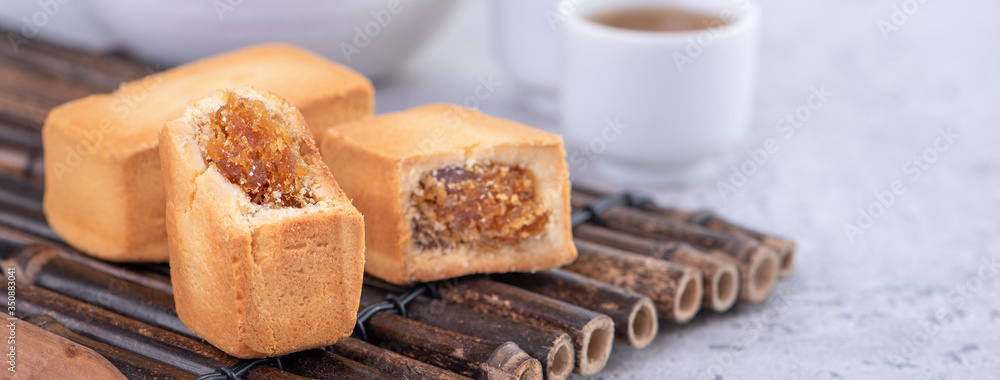 Pineapple cake pastry - Taiwanese famous sweet delicious dessert food with tea, close up, copy space