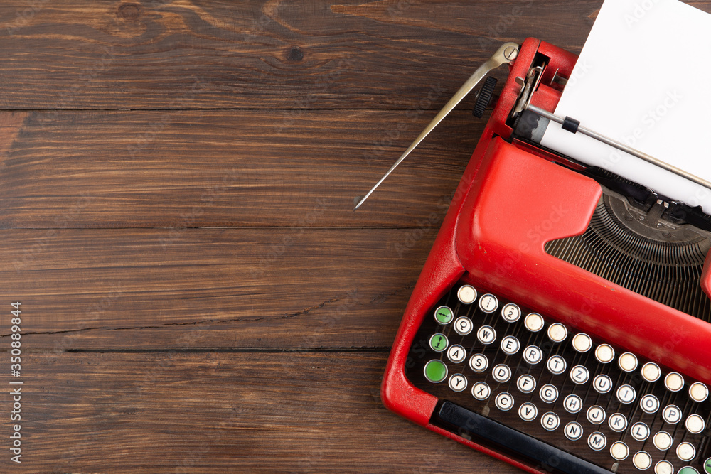 Journalism or blogging concept vintage typewriter on the wooden desk, top view