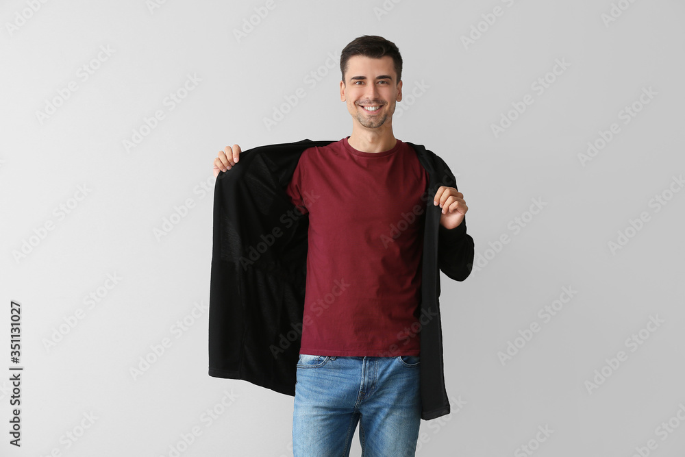 Man in stylish t-shirt on grey background