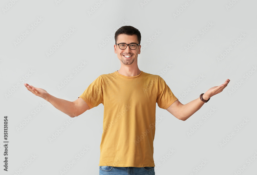 Man in stylish t-shirt on grey background