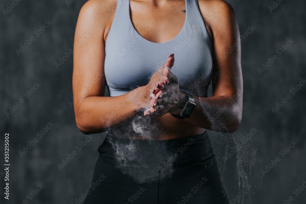 Fit woman using chalk powder