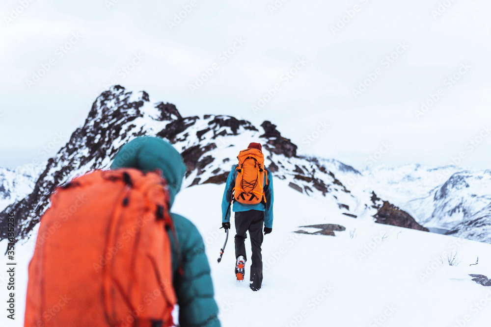 Backpackers hiking up Segla mountain, Norway