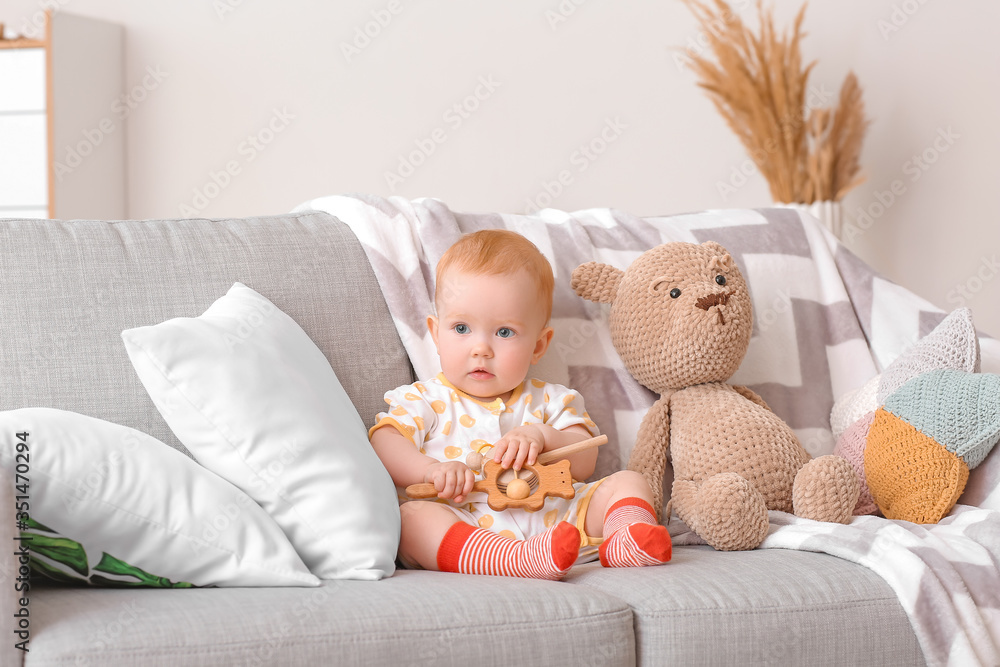 Cute little baby with toys at home