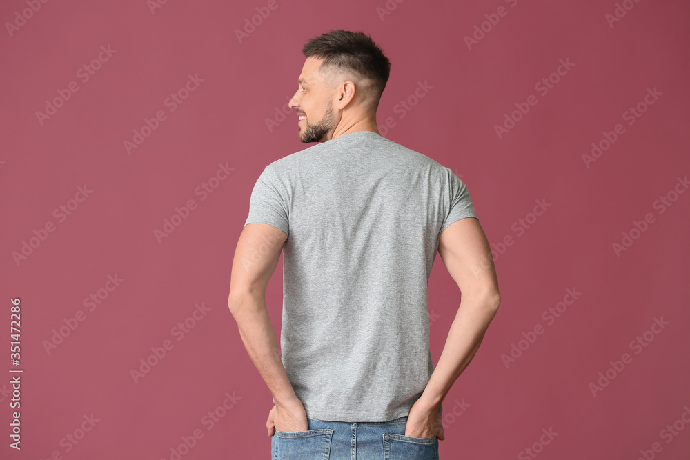 Man in stylish t-shirt on color background